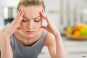 Stressed-looking woman touching her temples